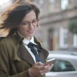 Shopping Apps - Stylish adult female using smartphone on street