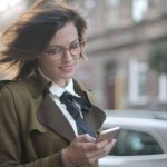 Shopping Apps - Stylish adult female using smartphone on street