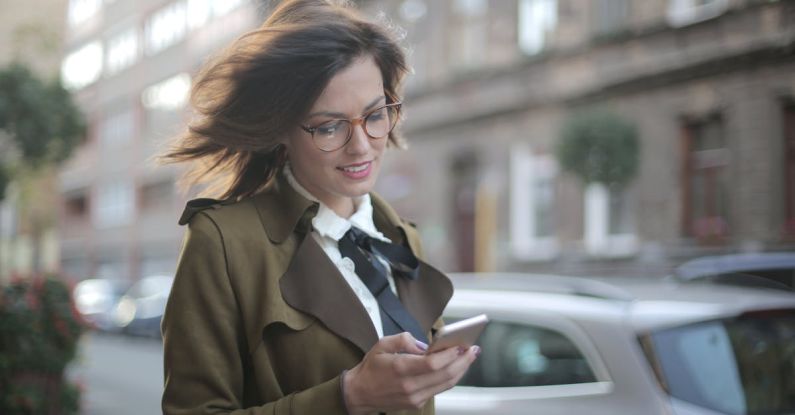Shopping Apps - Stylish adult female using smartphone on street
