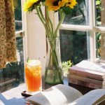Opened Book - Opened Book by Sunflowers in Glass Vase in Home