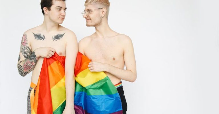 Holding Hands - Men With a Gay Pride Flag Holding Hands