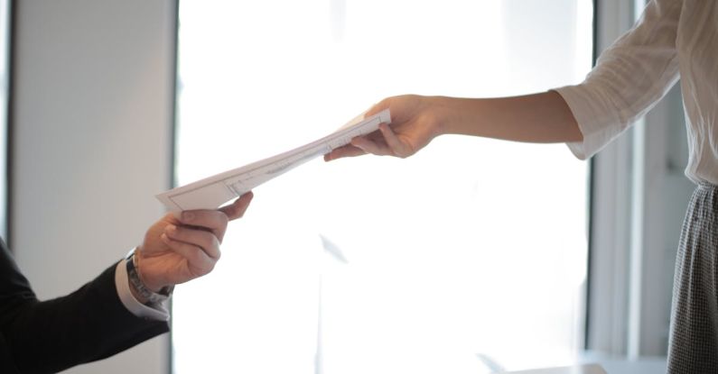 Resume Paper - Job Applicant Passing Her Documents