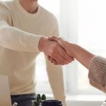 Interview Handshake - Man and Woman Near Table