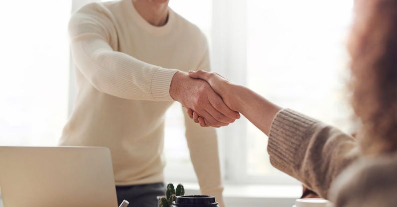 Interview Handshake - Man and Woman Near Table