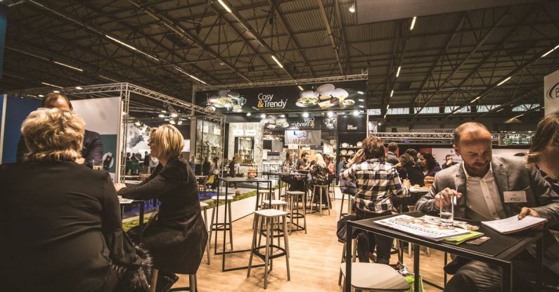 Networking Event - People Inside a Cafe With Tables and Chairs