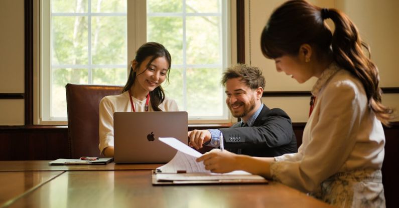 Mentorship Meeting - Three people sitting at a table with laptops