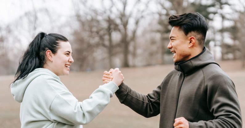 Handshake Money - Young positive Asian trainer supporting and giving hand to woman