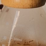 Brewing Kit - A coffee maker with a wooden handle and a glass lid