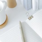 Open Journal - Notebook opened on desk near books