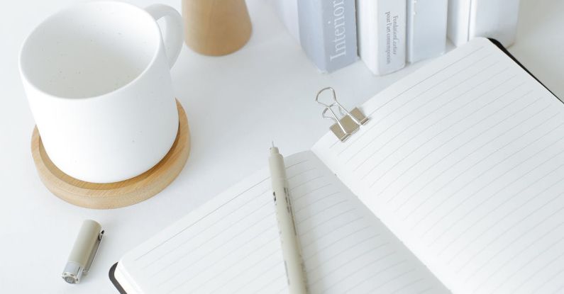 Open Journal - Notebook opened on desk near books