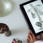 Digital Classroom - Unrecognizable African American scientist studying anatomy with tablet