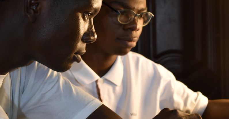 IoT Devices - Two young men are working on a laptop