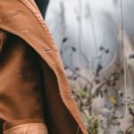 Eco Fashion - Stylish woman in trendy coat in field with dry grass