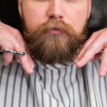 Beard Grooming - Man in White and Gray Pinstripe Having a Haircut