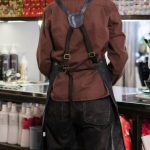 Hair Salon - Woman in Brown Leather Jacket and Black Pants Standing Near Counter