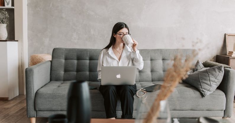 Productivity Software - Woman Drinking Coffee While Working With Laptop