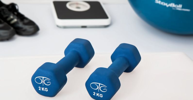 Home Gym - Two 2 Kg. Blue Hex Dumbbells on White Surface