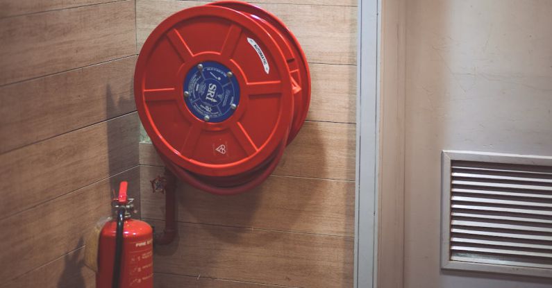 Fire Extinguisher - Red Fire Extinguisher below Hose Reel