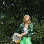 Container Plants - Woman in Green Pants Putting Oranges on Grass Field