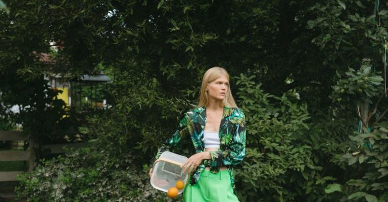 Container Plants - Woman in Green Pants Putting Oranges on Grass Field