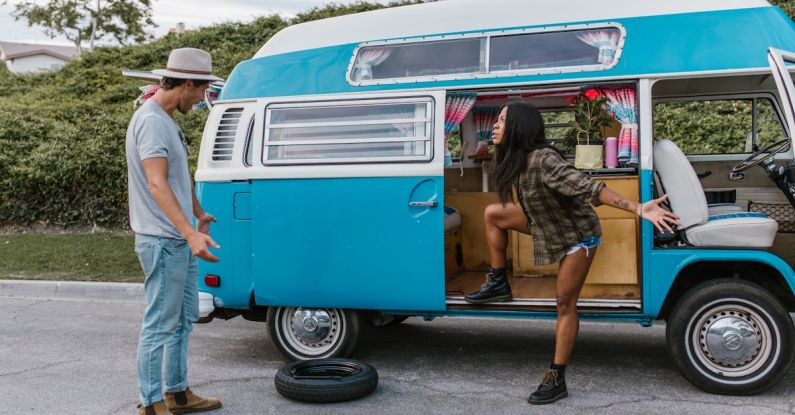 Spare Tire - Couple Arguing over a Flat Tire in Their Campervan