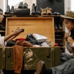 Second Hand - Women Looking at the Clothes in the Wooden Box