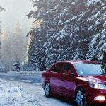 Winter Driving - Red Sedan in the Middle of Forest