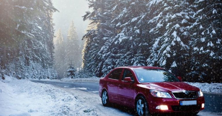 Winter Driving - Red Sedan in the Middle of Forest