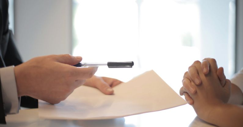 Insurance Policy - Crop businessman giving contract to woman to sign