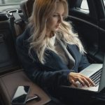 Car Gadgets - Woman in Blue Coat Sitting on Car Seat