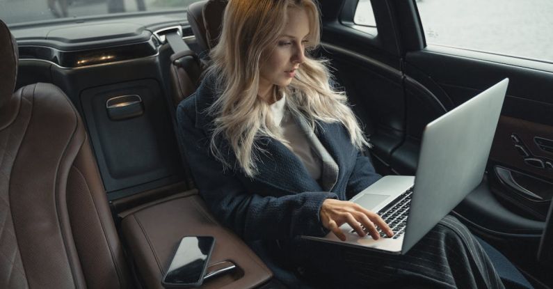 Car Gadgets - Woman in Blue Coat Sitting on Car Seat