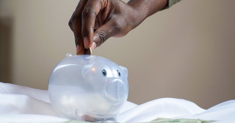 Piggy Bank - Person Putting Coin in a Piggy Bank