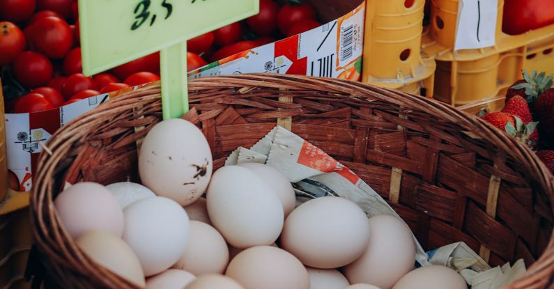 Future Retail - A basket of eggs and tomatoes at a farmers market