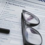 Insurance Policy - Black Framed Eyeglasses on White Paper