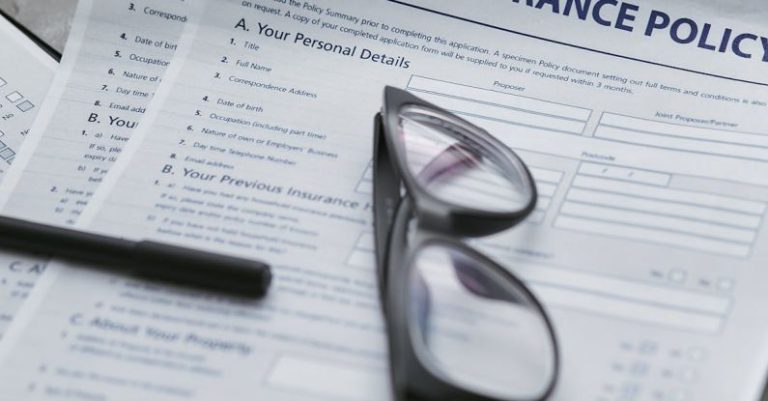 Insurance Policy - Black Framed Eyeglasses on White Paper