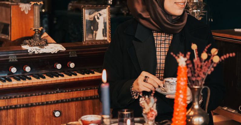 Cluttered Room - Hijabi Woman Sitting in Cluttered Room by Glass Table